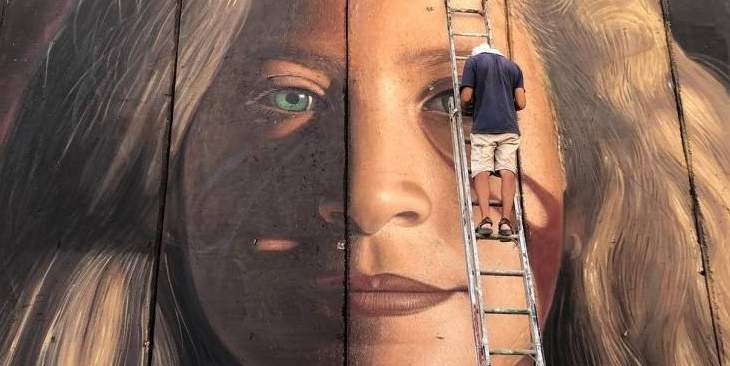 الشرطة الإسرائيلية أفرجت عن إيطاليين رسما لوحة جدارية لعهد التميمي